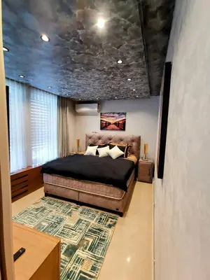 a bedroom with a bed and a rug at HELGA apartmani BOSS i PRESIDENT in Kraljevo