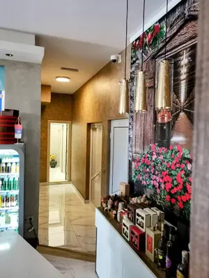 a lobby of a restaurant with flowers on the wall at HELGA apartmani BOSS i PRESIDENT in Kraljevo
