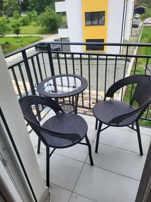 two chairs and a table on a balcony at Apartman '' PETICA'' in Vrnjačka Banja