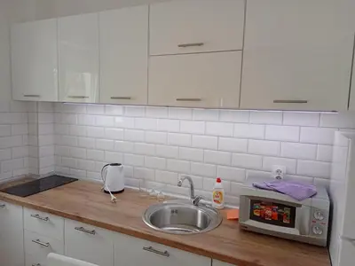 a kitchen counter with a sink and a microwave at Apartman '' PETICA'' in Vrnjačka Banja