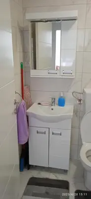 a bathroom with a sink and a mirror and a toilet at Apartman '' PETICA'' in Vrnjačka Banja