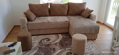 a brown couch sitting in a living room at Apartman '' PETICA'' in Vrnjačka Banja