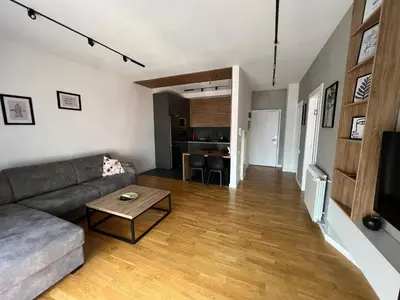 a living room with a couch and a table at Leo Lux 2 in Niš