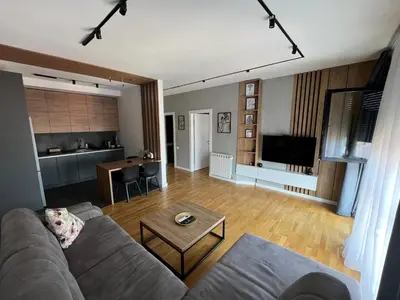 a living room with a couch and a table at Leo Lux 2 in Niš