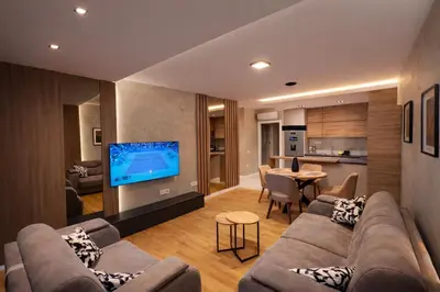 a living room with a large couch and a television at Leo Lux 2 in Niš
