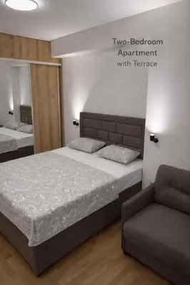 a bedroom with a bed and a couch at Leo Lux 2 in Niš