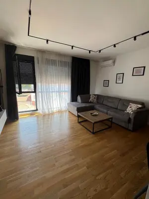 a living room with a couch and a table at Leo Lux 2 in Niš