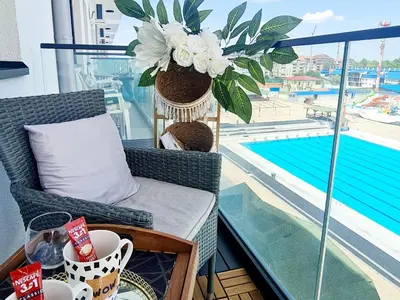 a balcony with a chair and a table with a plant at RELAX LUX AKVA PARK(K-KOMPLEX) in Jagodina