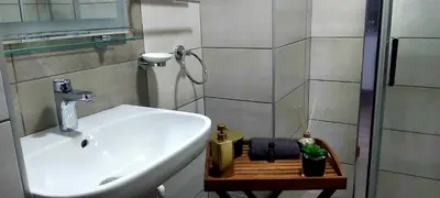 a bathroom with a sink and a shower at RELAX LUX AKVA PARK(K-KOMPLEX) in Jagodina