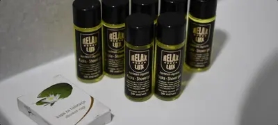 a group of black bottles of hair oil next to a box at RELAX LUX AKVA PARK(K-KOMPLEX) in Jagodina