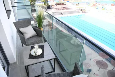 a balcony with a view of a swimming pool at RELAX LUX AKVA PARK(K-KOMPLEX) in Jagodina