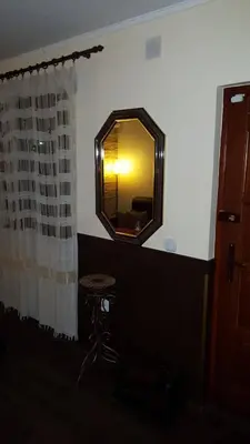 a mirror on the wall of a bathroom with a stool at Holiday Home Di More in Jagodina