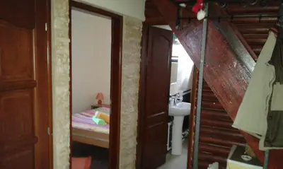 a bedroom with a bed and a bathroom with a sink at Holiday Home Di More in Jagodina