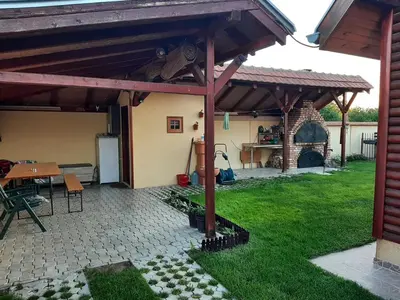 a patio with awning and a table and a grill at Holiday Home Di More in Jagodina