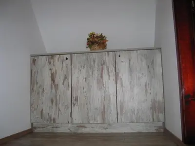 a wooden wall with a potted plant on top of it at Holiday Home Di More in Jagodina