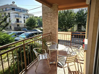 a patio with a table and chairs on a balcony at Apartmani TRIO in Vrnjačka Banja
