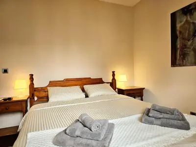 a bedroom with two beds with towels on them at Apartmani TRIO in Vrnjačka Banja