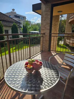 a bowl of fruit sitting on a table on a balcony at Apartmani TRIO in Vrnjačka Banja