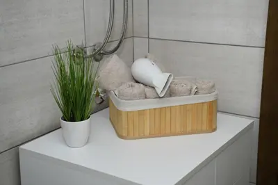 a basket of stuffed animals sitting on a shelf in a bathroom at Apartman Zara - free private parking - in Jagodina