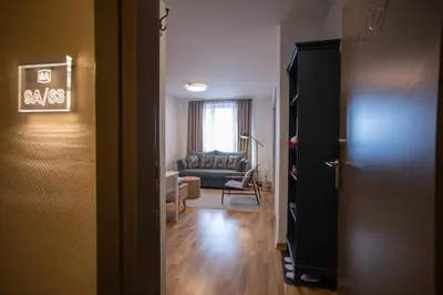 a hallway with a living room with a couch at Cardak u Sumi (Forest house) in Kopaonik