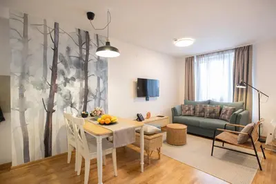 a living room with a table and a couch at Cardak u Sumi (Forest house) in Kopaonik