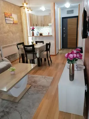 a living room with a table and a dining room at Panorama in Vrnjačka Banja