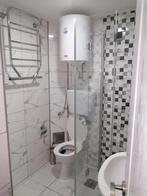 a bathroom with a toilet and a glass shower at Panorama in Vrnjačka Banja