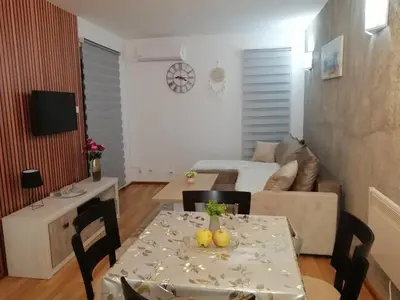 a living room with a table with fruit on it at Panorama in Vrnjačka Banja