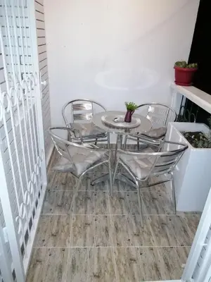 a dining table and chairs on a floor at Panorama in Vrnjačka Banja