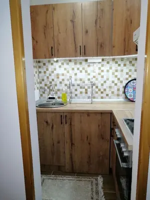 a kitchen with wooden cabinets and a sink at Panorama in Vrnjačka Banja