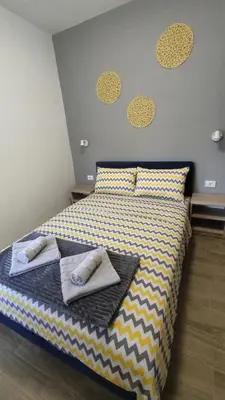 a bedroom with a bed with two towels on it at Apartman 2 Miljković in Soko Banja
