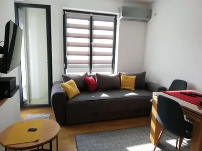 a living room with a couch and a table at Mali Raj in Soko Banja