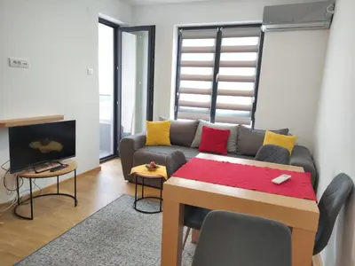 a living room with a couch and a table at Mali Raj in Soko Banja