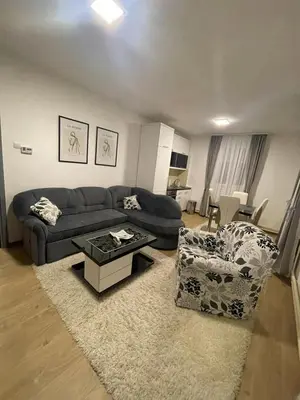 a living room with a couch and a table at TRG In in Vrnjačka Banja