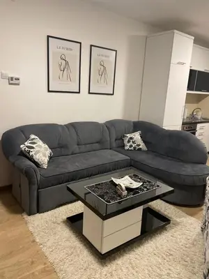 a living room with a couch and a coffee table at TRG In in Vrnjačka Banja