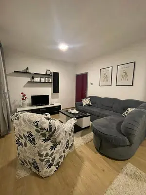 a living room with a couch and a chair at TRG In in Vrnjačka Banja