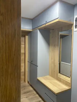 a room with blue walls and wooden cabinets at Iris Apartment in Vrnjačka Banja