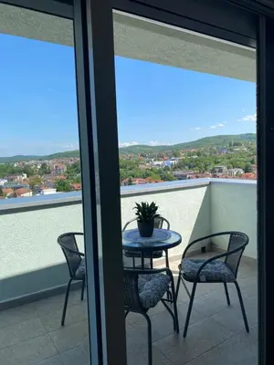 a table and chairs on a balcony with a view at Iris Apartment in Vrnjačka Banja