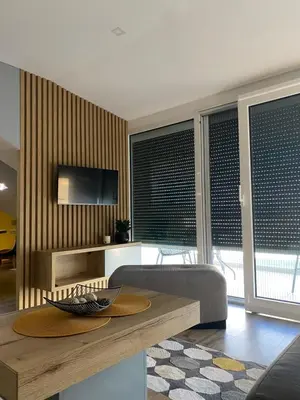 a living room with a table and a couch at Iris Apartment in Vrnjačka Banja