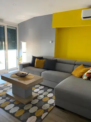 a living room with a couch and a coffee table at Iris Apartment in Vrnjačka Banja