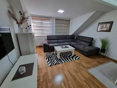 a living room with a couch and a table at Silver city 2 in Jagodina