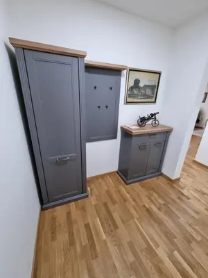 a room with two gray doors and a wooden floor at Silver city 2 in Jagodina