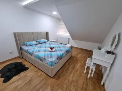 a small bedroom with a bed and a desk at Silver city 2 in Jagodina