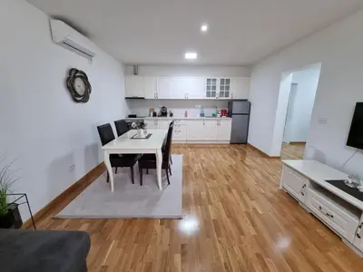 a kitchen and living room with a table and chairs at Silver city 2 in Jagodina