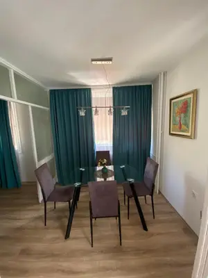 a dining room with a glass table and chairs at Delta 10 in Niš