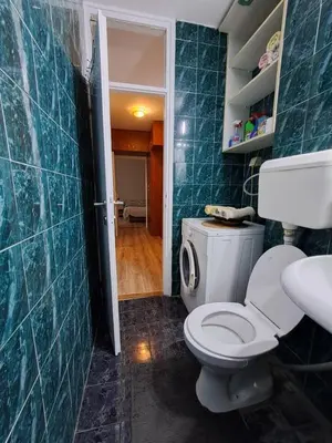 a bathroom with a toilet and a sink at Delta 10 in Niš