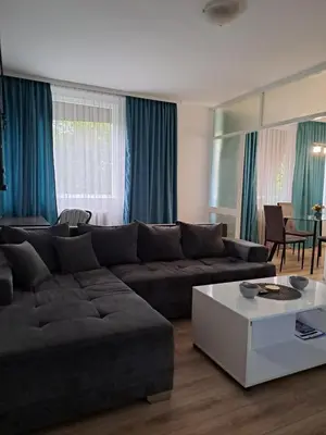 a living room with a couch and a table at Delta 10 in Niš