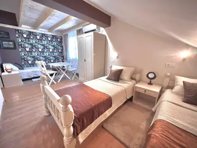 a bedroom with two beds and a dining room at International Inn in Paraćin