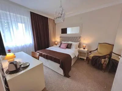 a hotel room with a bed and a chair at International Inn in Paraćin