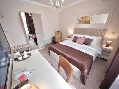 a bedroom with a bed and a table and a mirror at International Inn in Paraćin